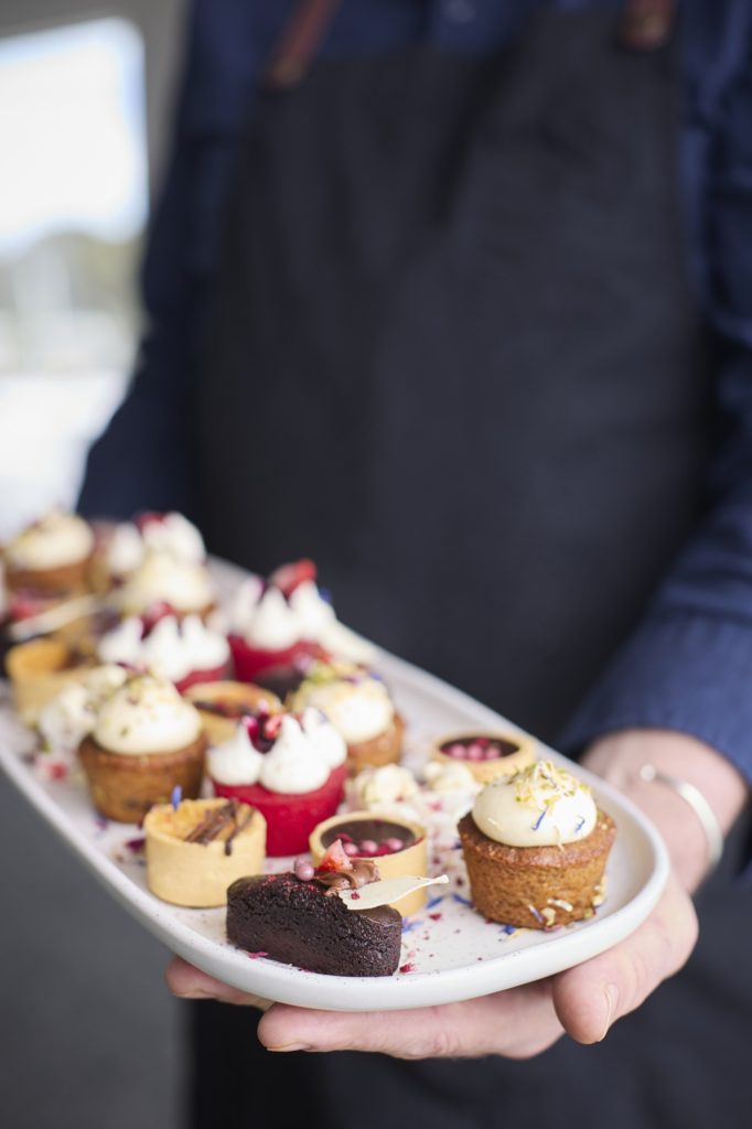 Birthday party catering, handing out sweet treats to all the guests.