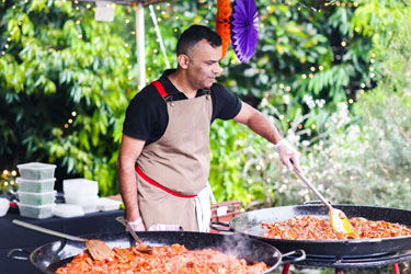 Chef cooking paella catering for an event